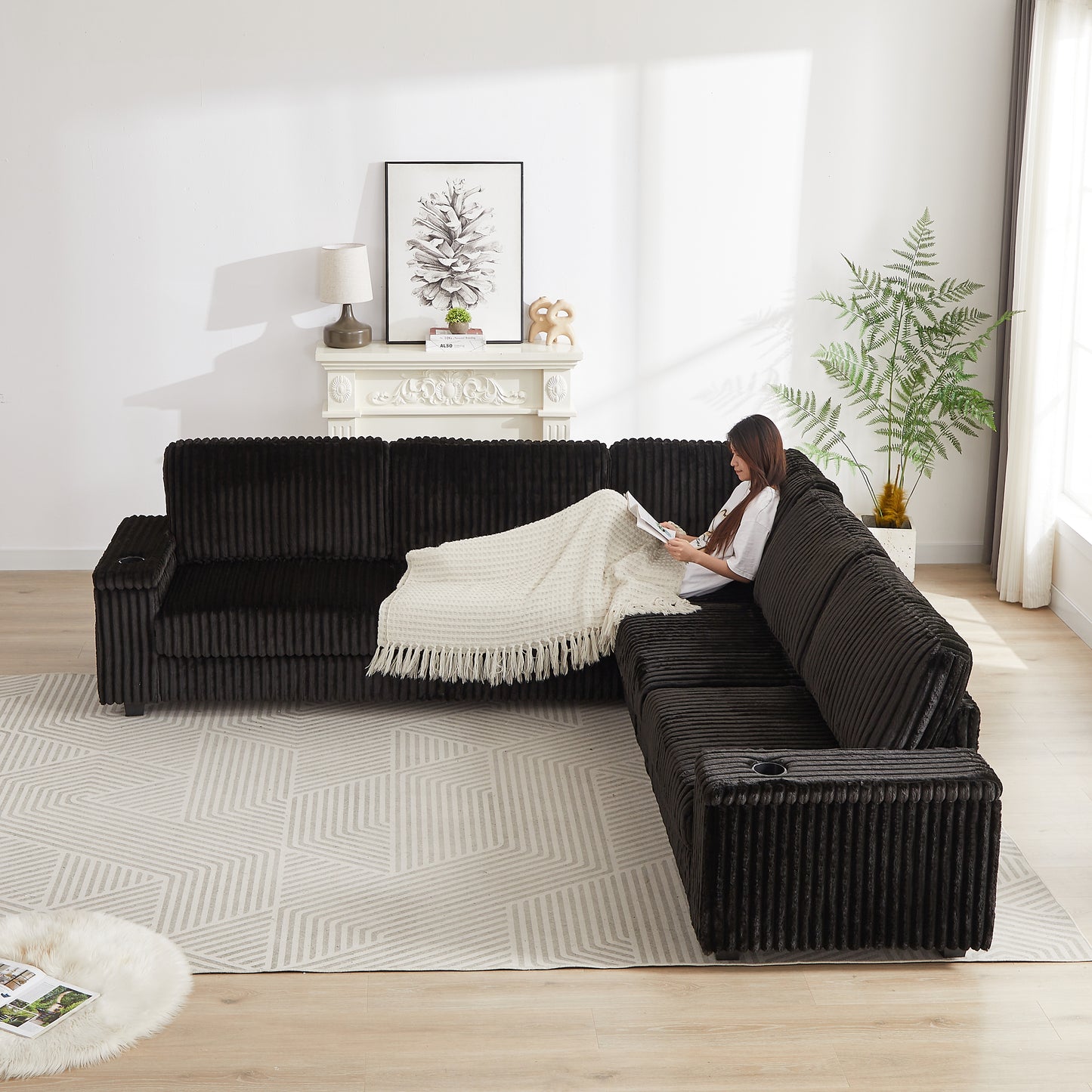 Black corduroy sectional sofa with a textured fabric and builtin cup holder