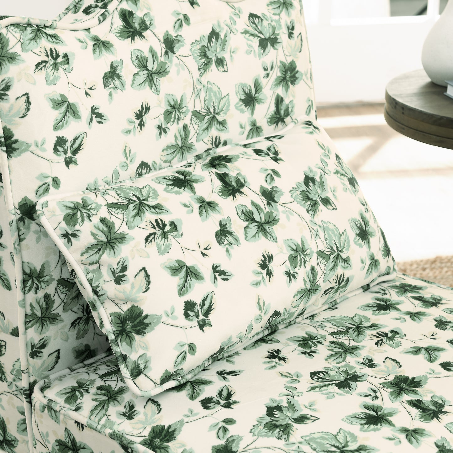 Cream armchair with a green floral leaf pattern accent pillow included