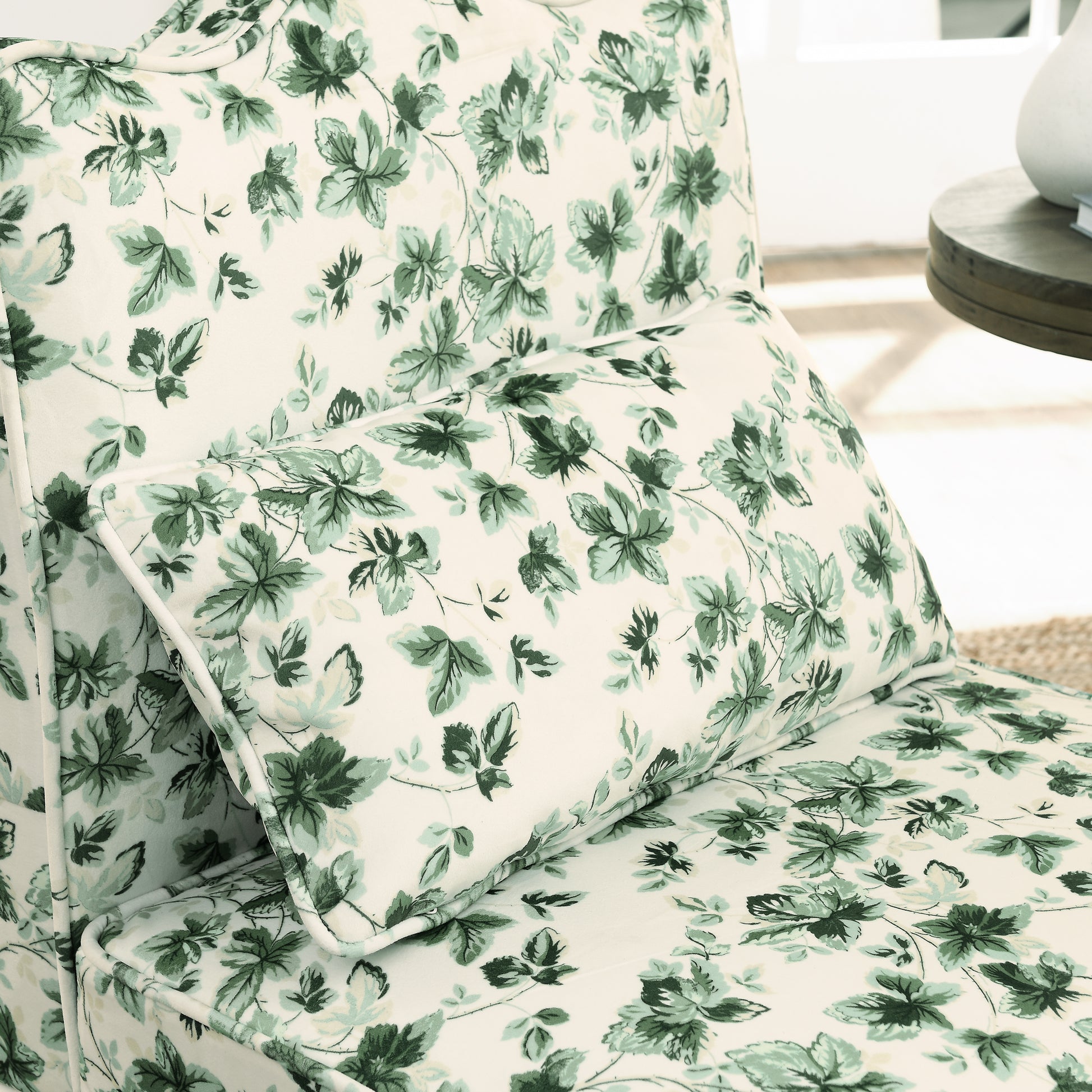 Cream armchair with a green floral leaf pattern accent pillow included