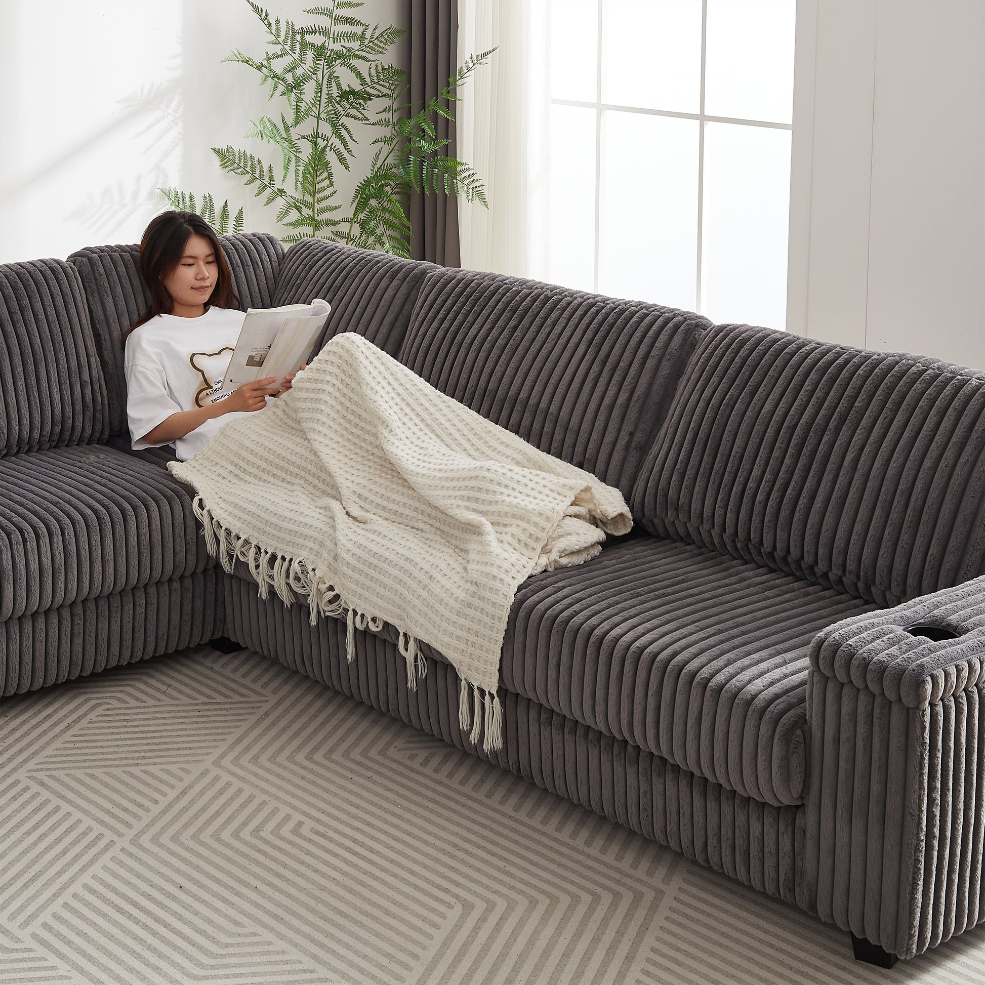 Plush grey corduroy sectional sofa with integrated cup holder perfect for living rooms