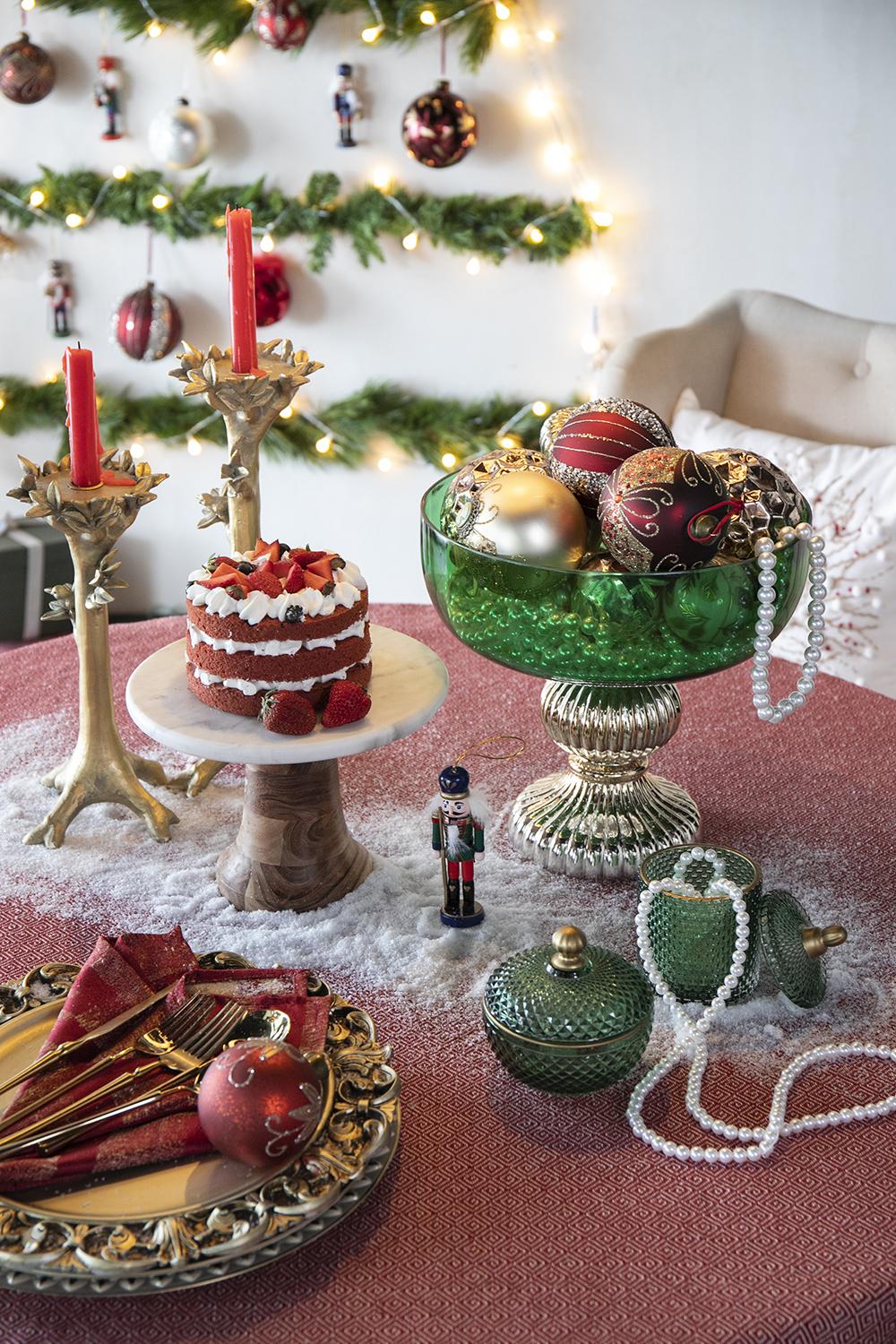Festive tiered cake with strawberries whipped cream and blueberries on a marble stand