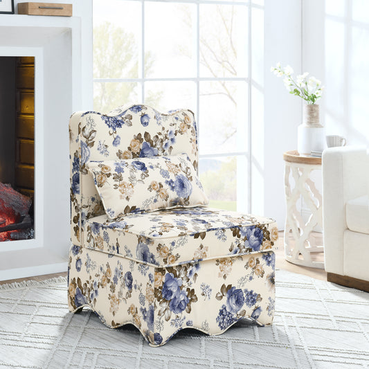 Cream accent chair with blue and tan floral print upholstery matching throw pillow