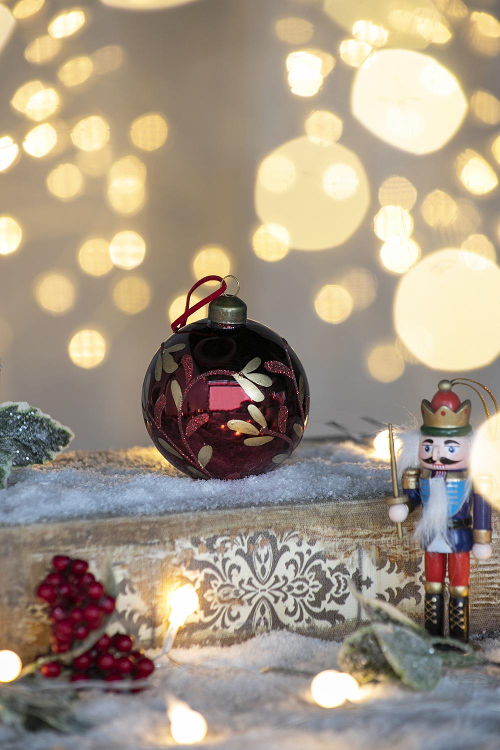 Red glass Christmas ornament with gold vine detail and glitter