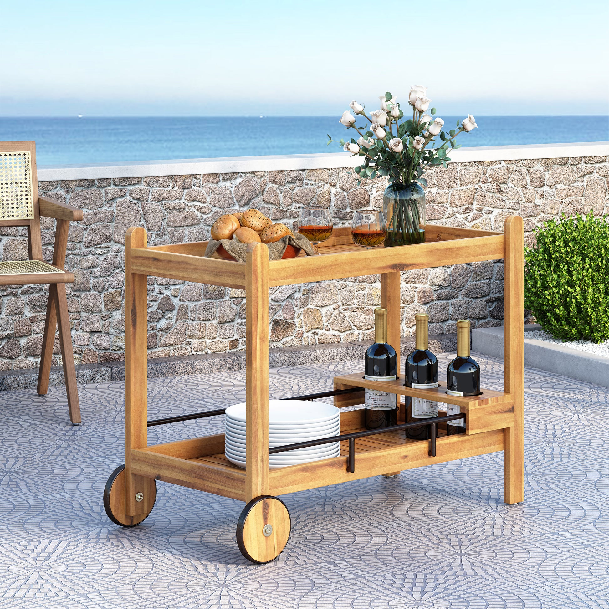 Wooden patio bar cart with wheels holding wine bottles and plates