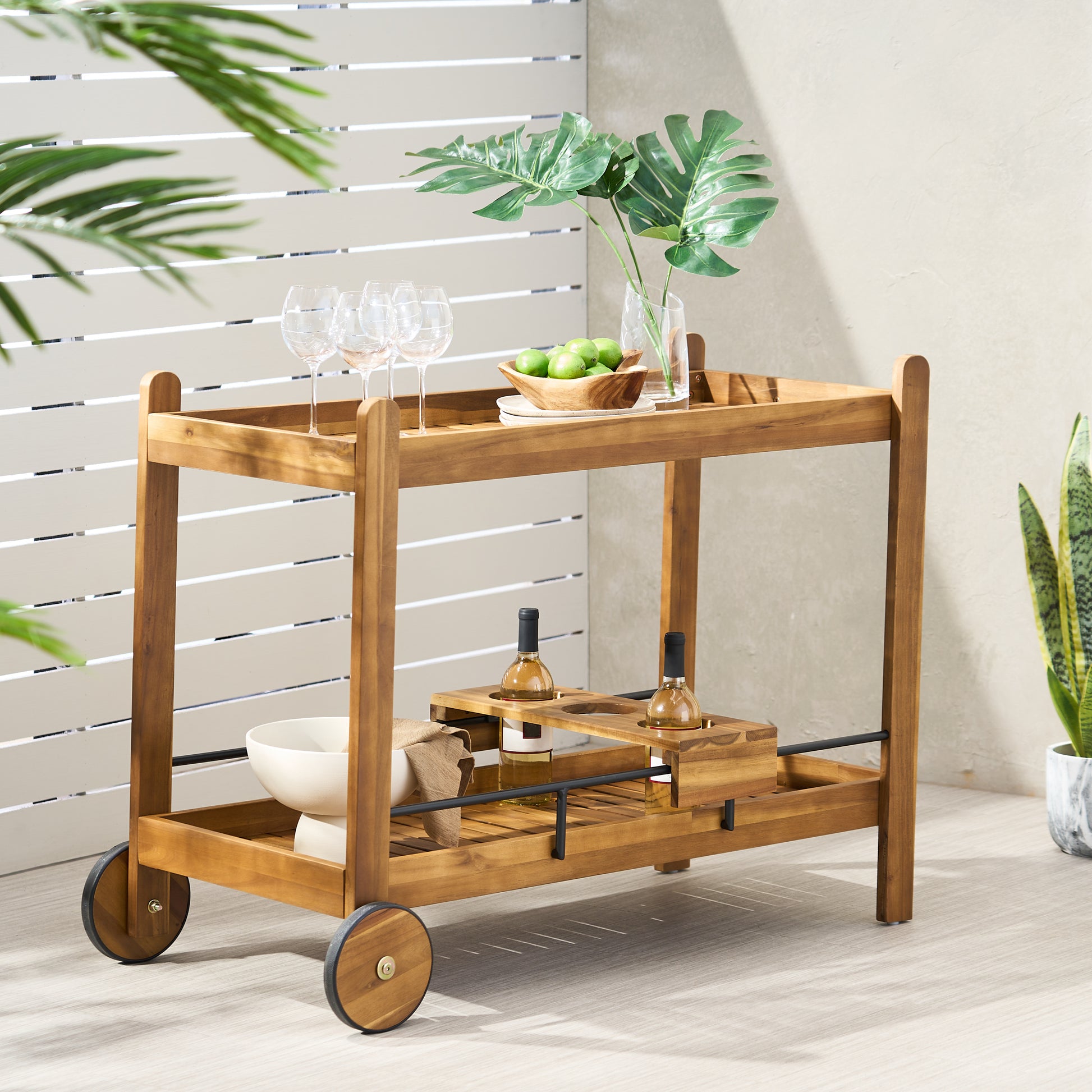 Wooden bar cart with wine bottles and glasses