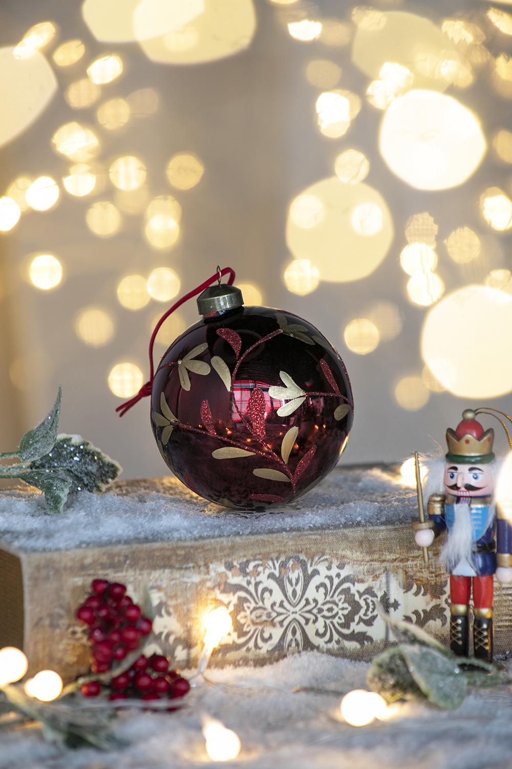 Deep red glass Christmas ornament with gold vine detail ideal for festive tree decor