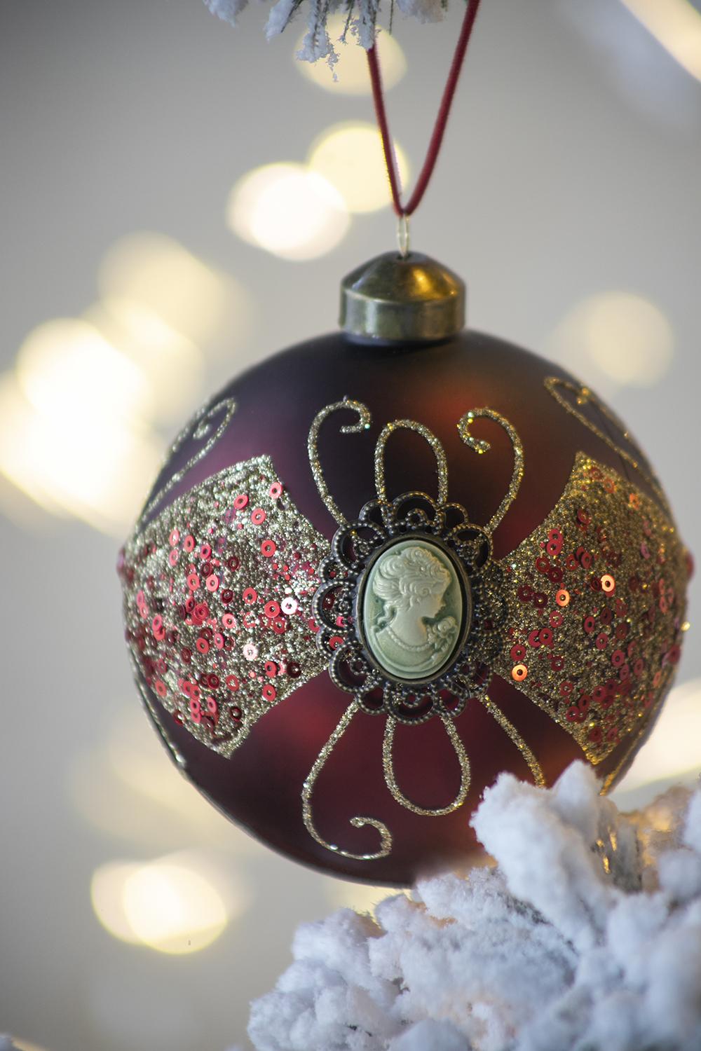 Ornate maroon Christmas ornament with cameo and sequins