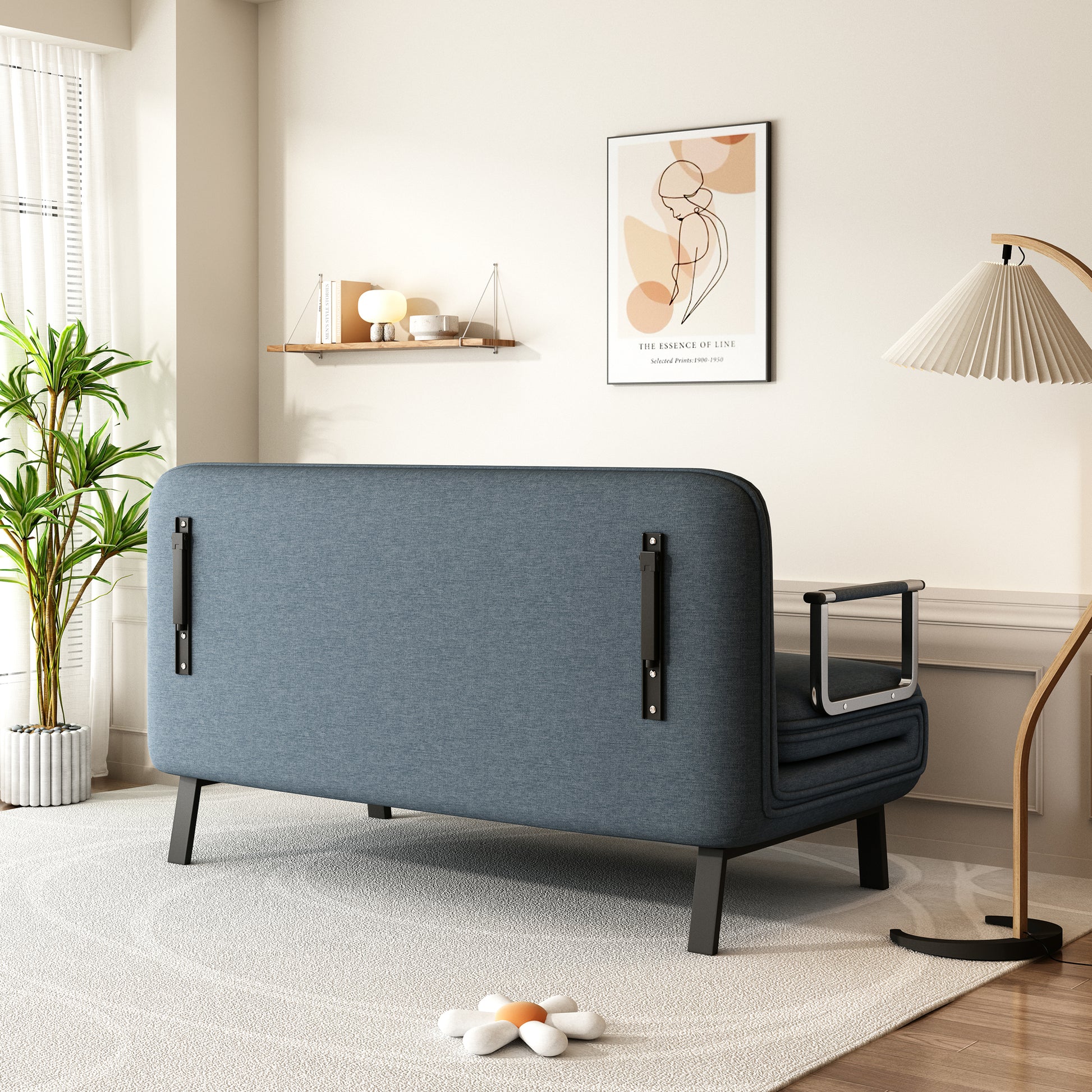 Dark blue fabric convertible sofa with metal armrests and black legs