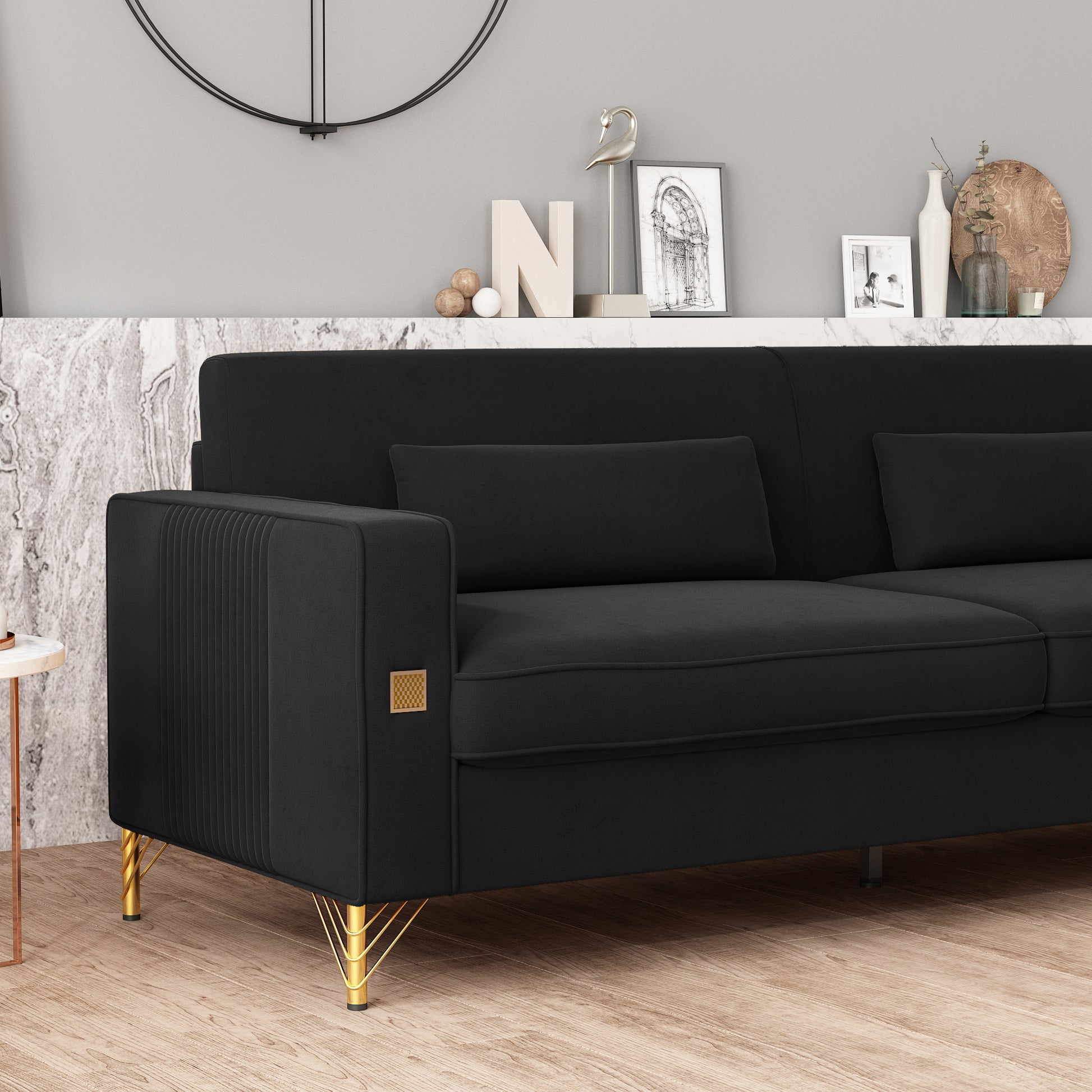 Black velvet sofa with fluted arms and gold legs for a modern living room