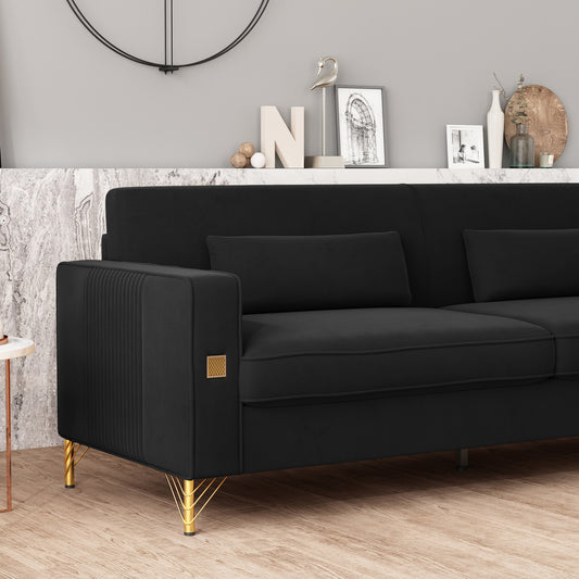 Black velvet sofa with fluted arms and gold legs for a modern living room