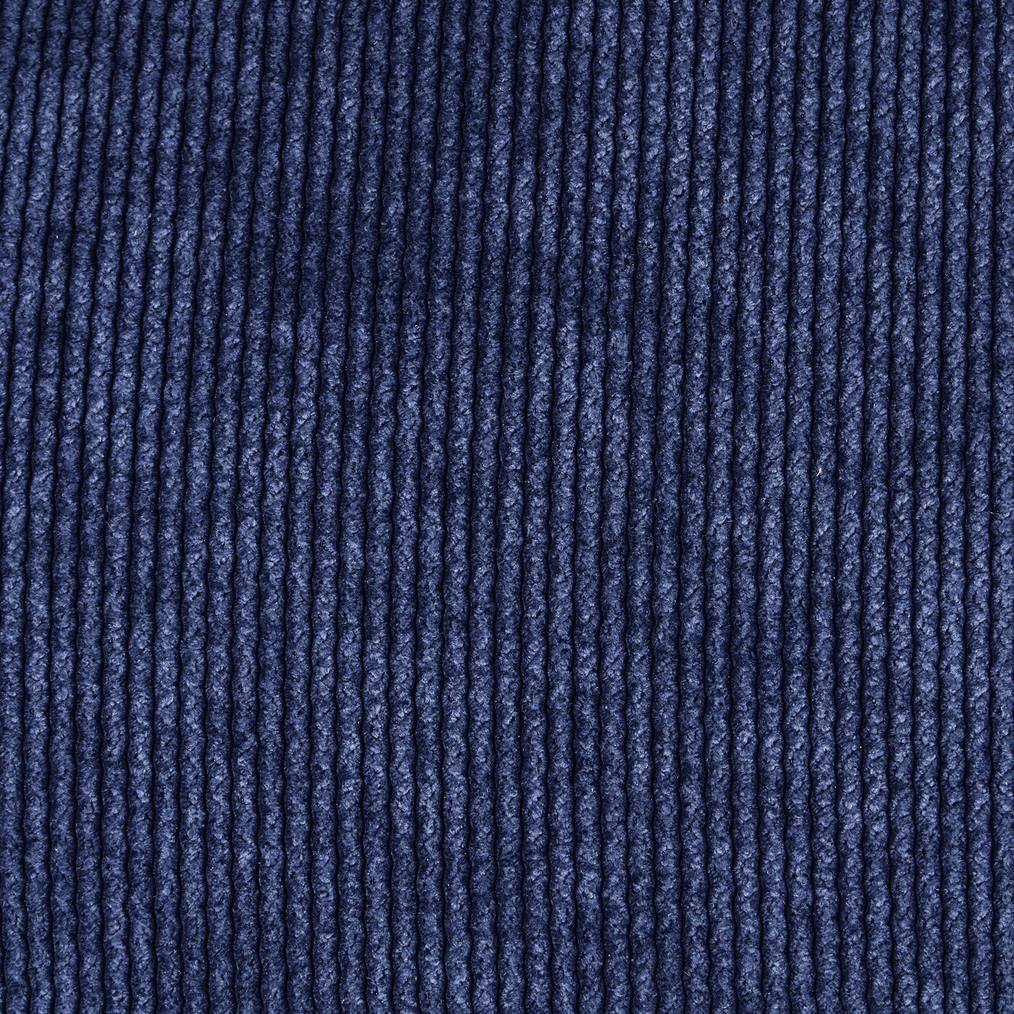 Closeup of dark navy blue corduroy fabric texture for apparel