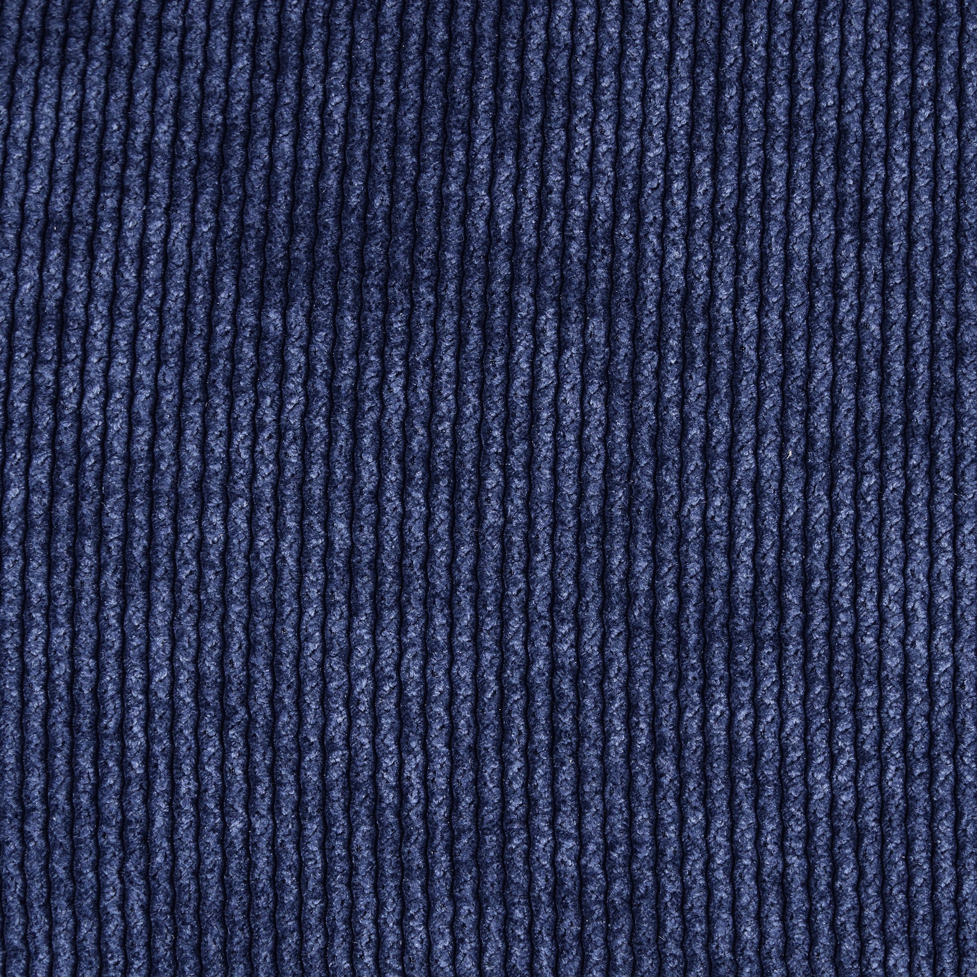 Closeup of dark navy blue corduroy fabric texture for apparel