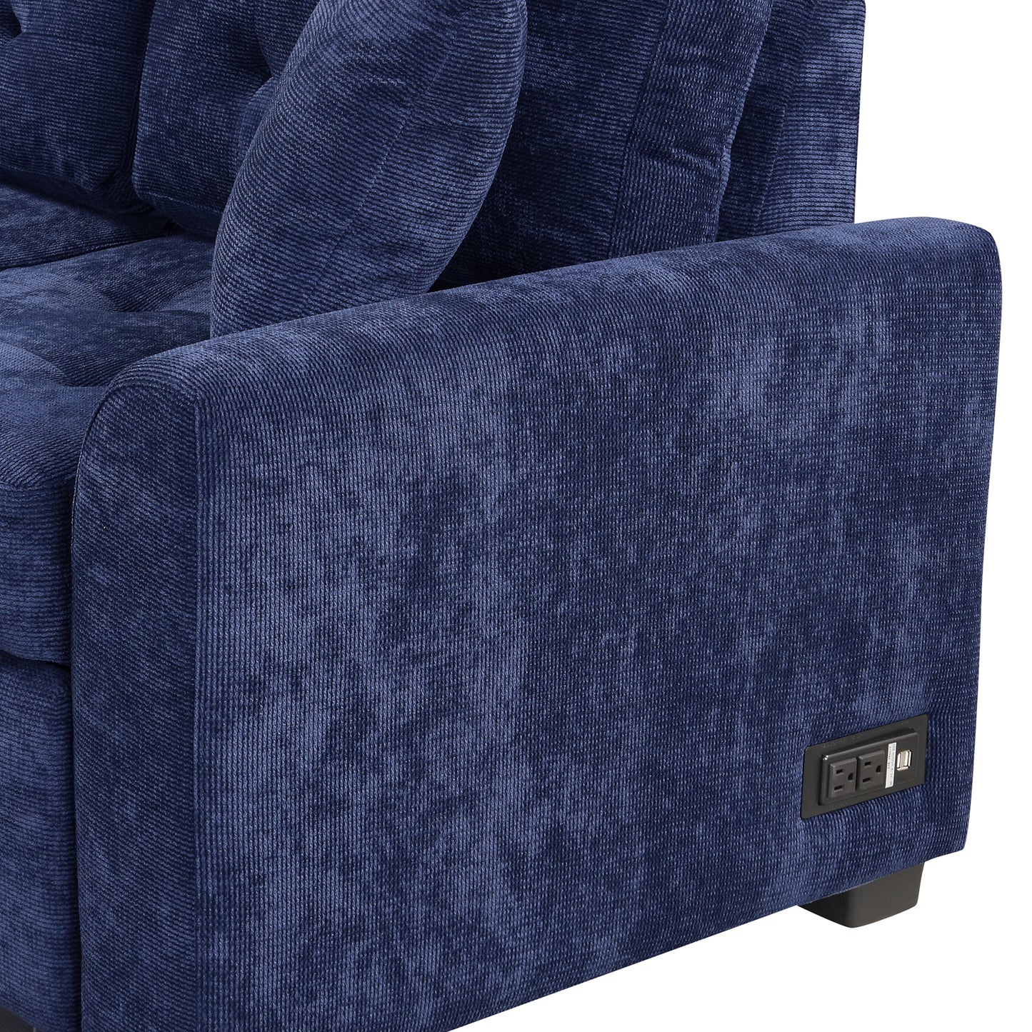 Closeup of a navy blue corduroy sofa armrest with builtin USB and AC outlets