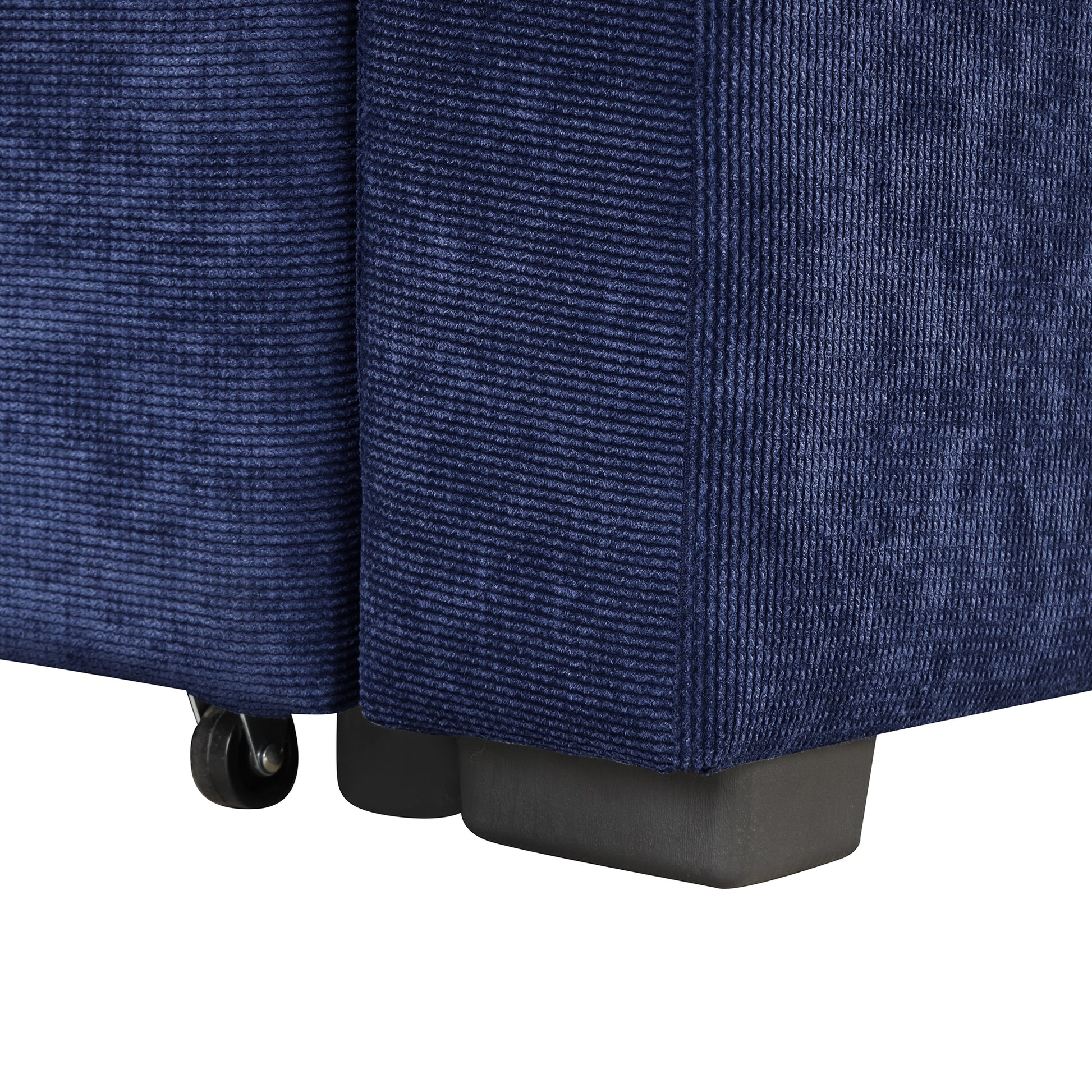 Closeup of navy blue corduroy fabric on a furniture piece with visible casters