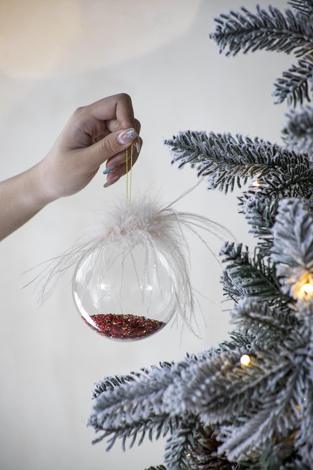 Clear glass Christmas ornament with red glitter fill and fluffy white feathers  characters