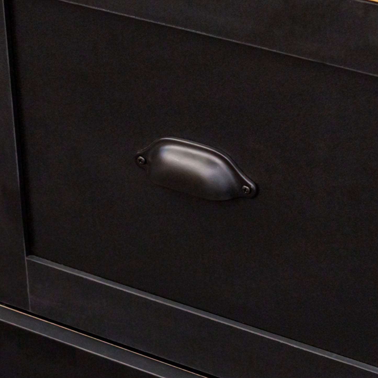 Black metal drawer pull on a dark cabinet vintage industrial style