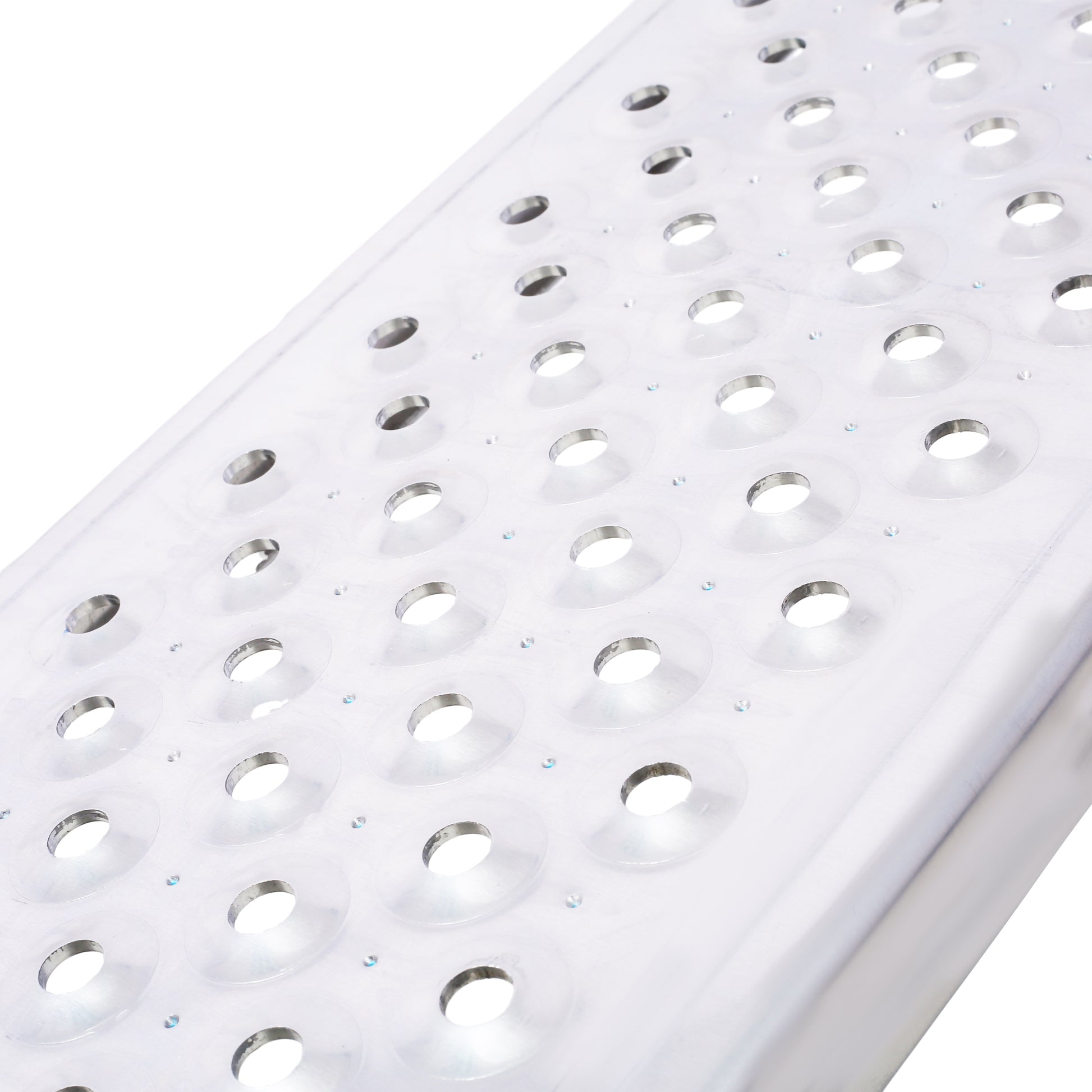 Closeup of silver aluminum diamond plate with embossed circular grip pattern