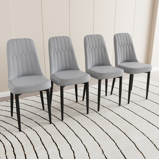 Set of four light grey upholstered dining chairs with diamond stitching detail