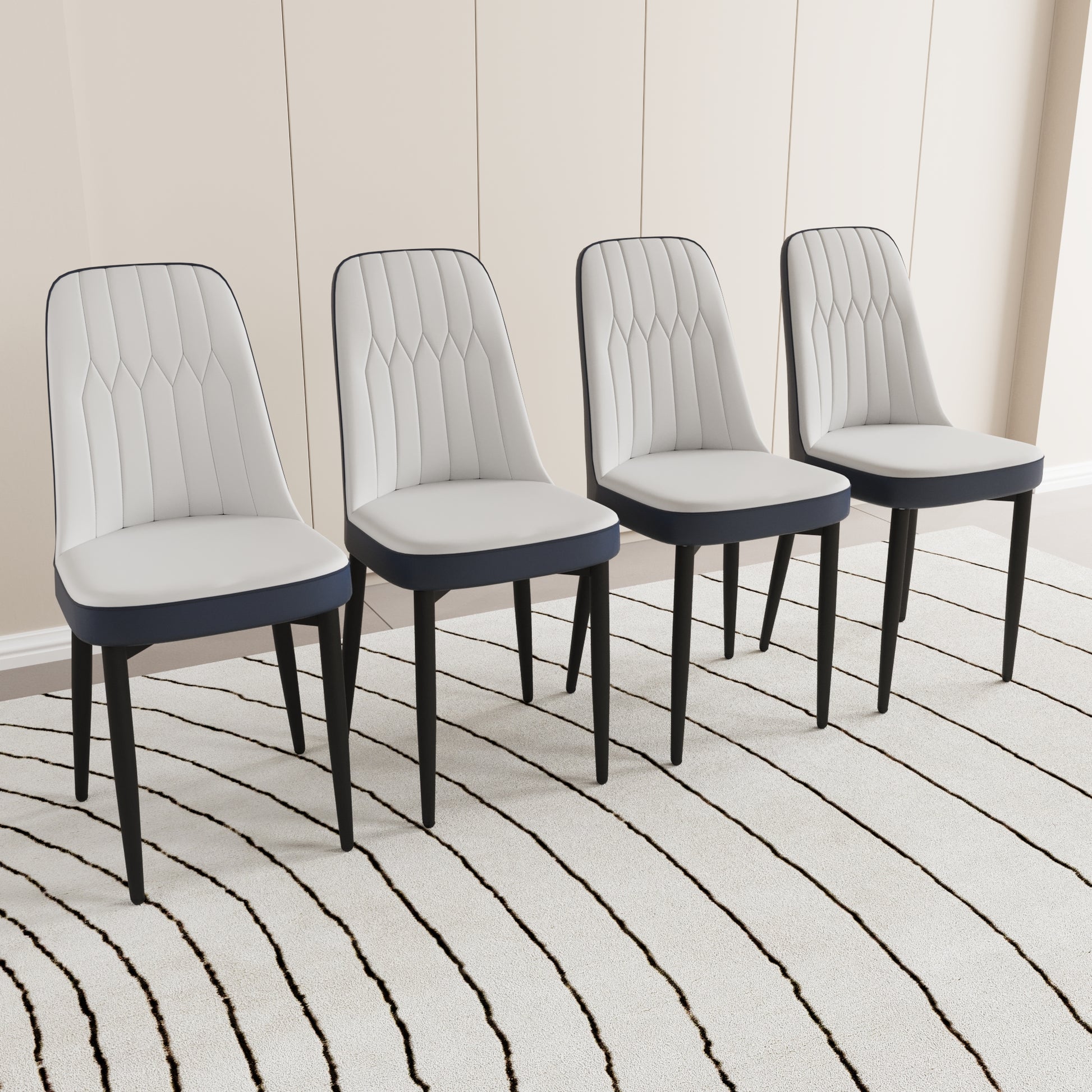 Four modern dining chairs with white tufted seats and navy blue accents