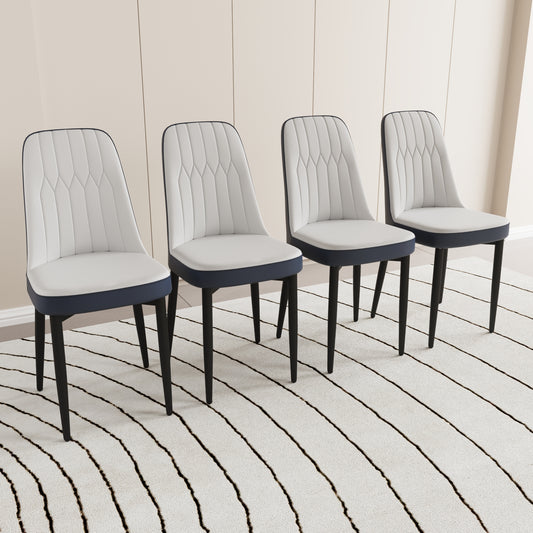 Four modern dining chairs with white tufted seats and navy blue accents