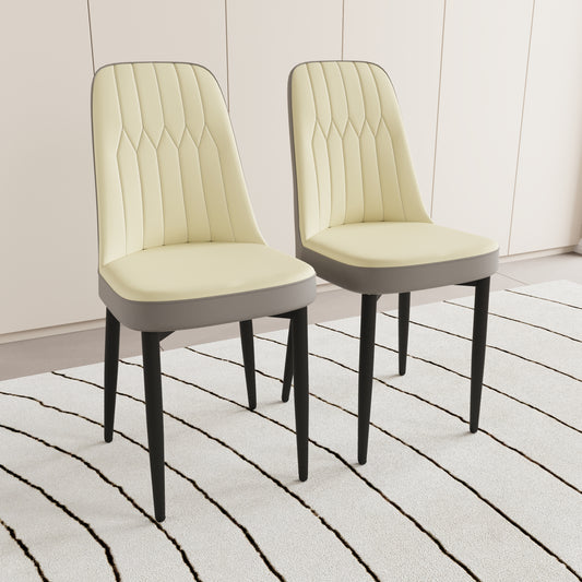 Two cream upholstered dining chairs with diamond stitching and grey trim