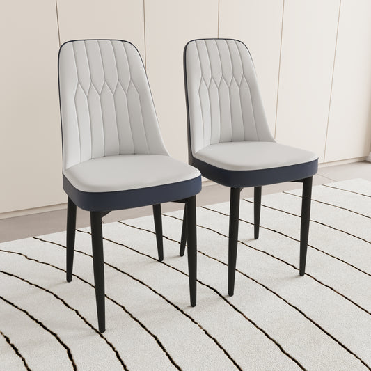 Two modern white upholstered dining chairs with dark blue accents and black legs on a striped rug