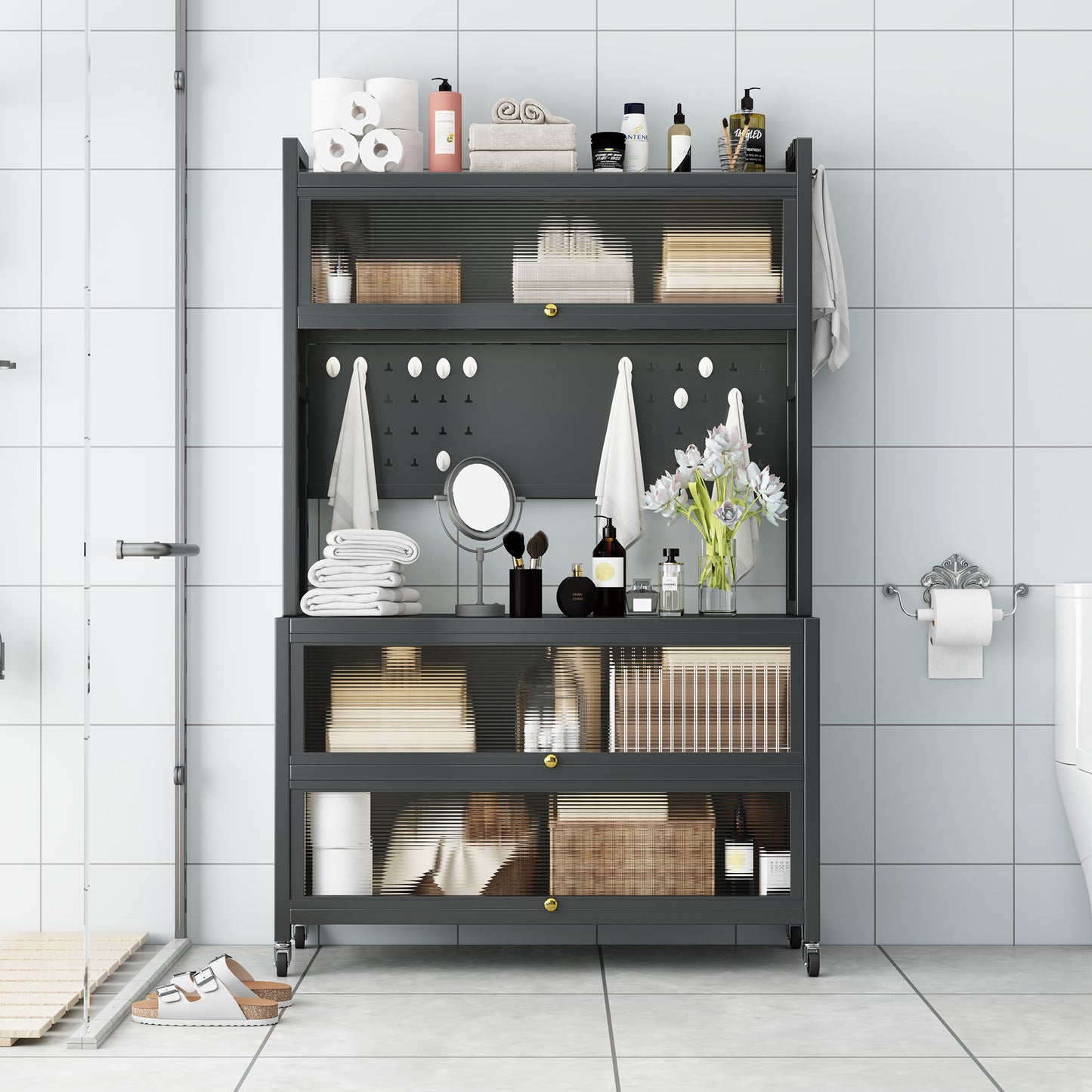 Dark grey metal bathroom shelving unit with clear ribbed glass doors and gold hardware