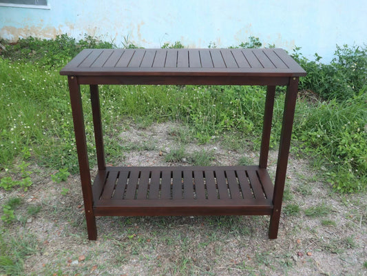 Dark brown slatted wood console table with two shelves perfect for outdoor decor