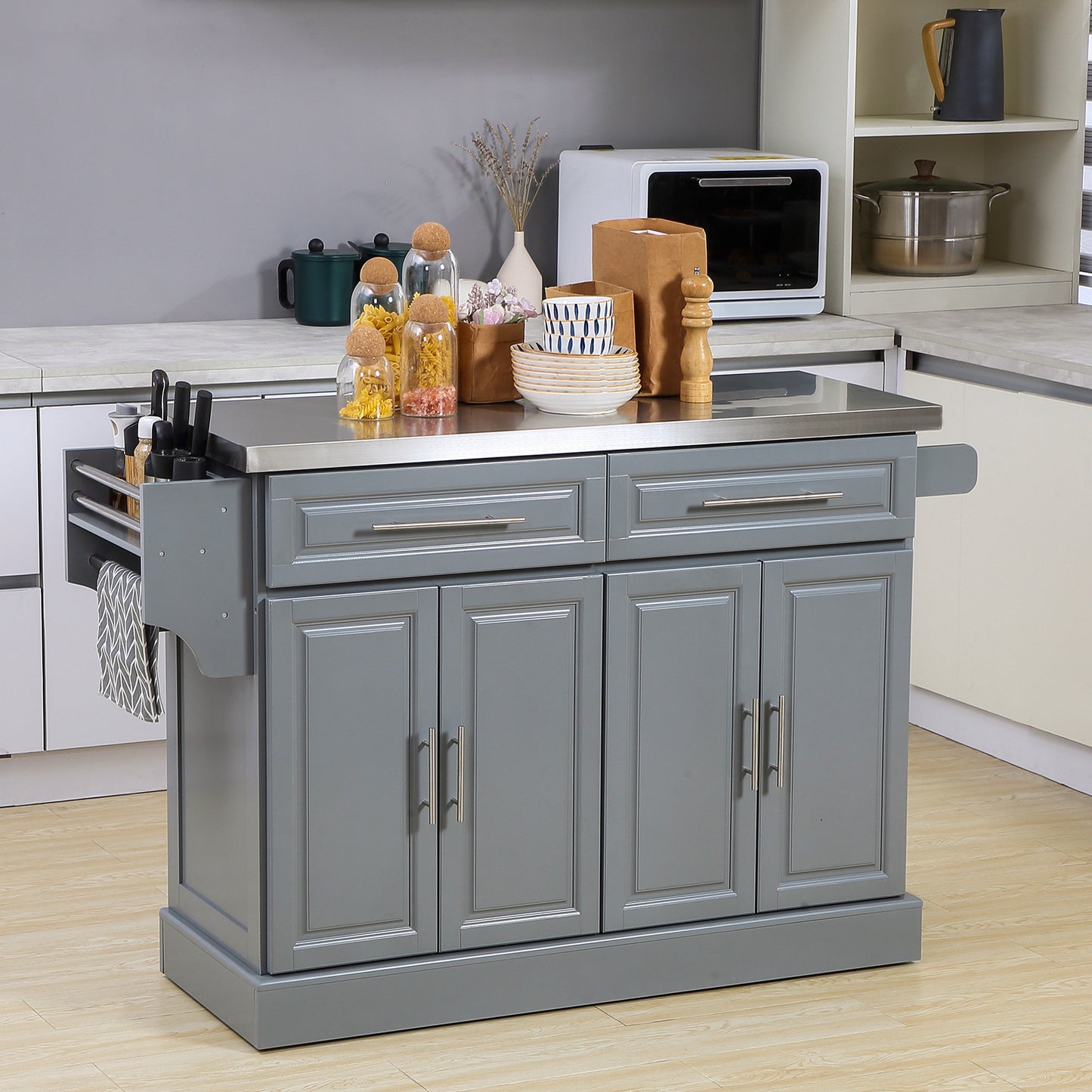 Gray kitchen island with stainless steel countertop and two drawers