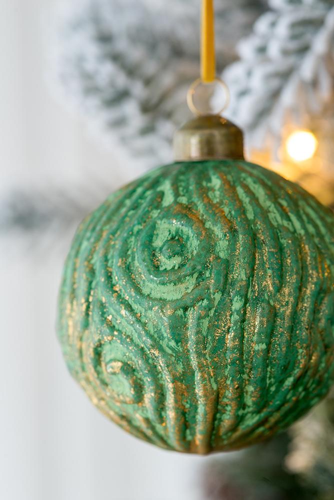 Textured green christmas ornament with gold accents spiral design detail
