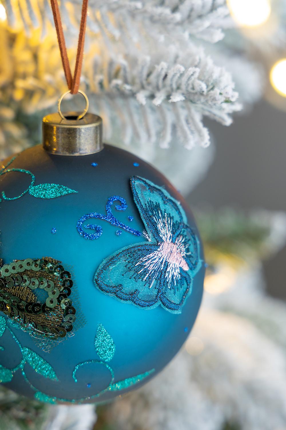 Teal glass Christmas ornament with embroidered butterfly and sequins detail