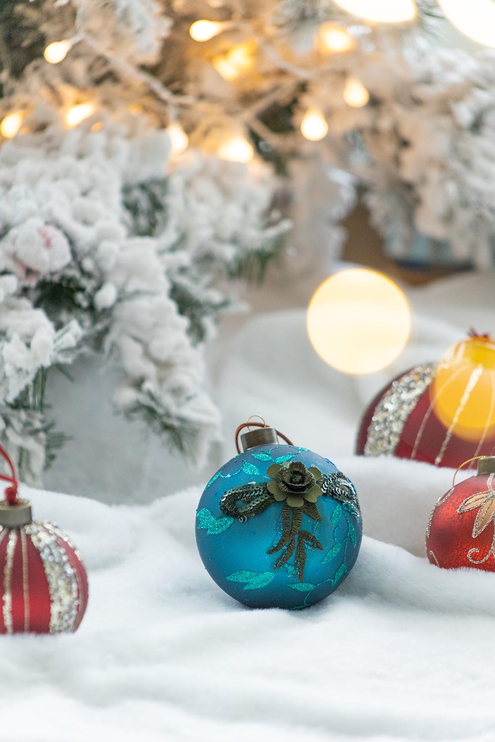 Turquoise glass Christmas ornament with beaded floral design and glitter detail