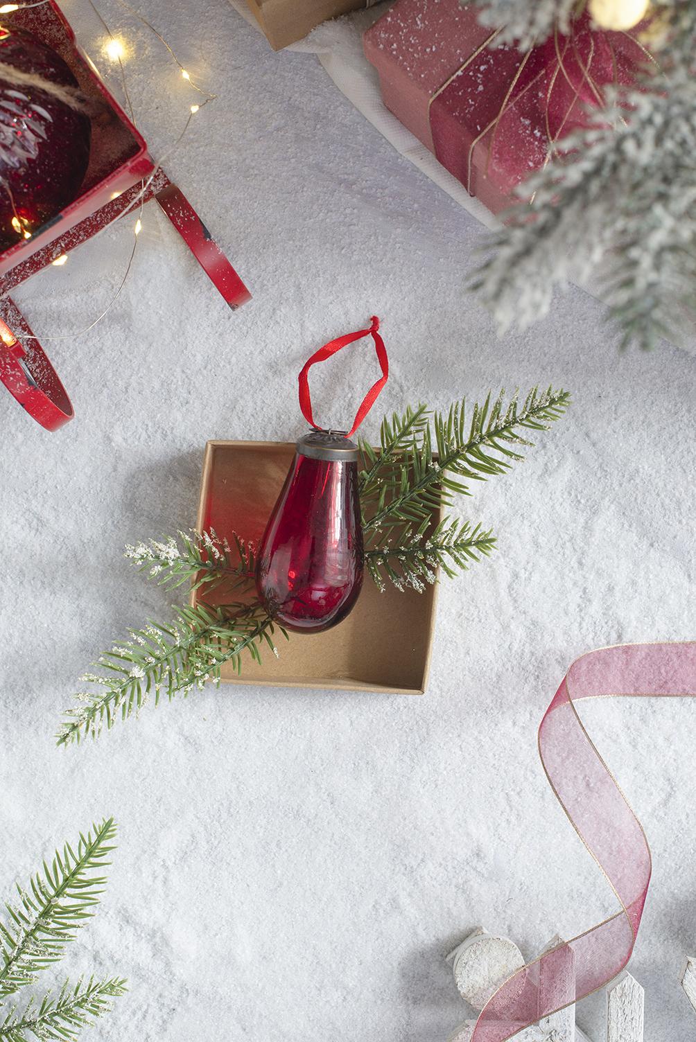 Red glass teardrop Christmas ornament with pine sprigs