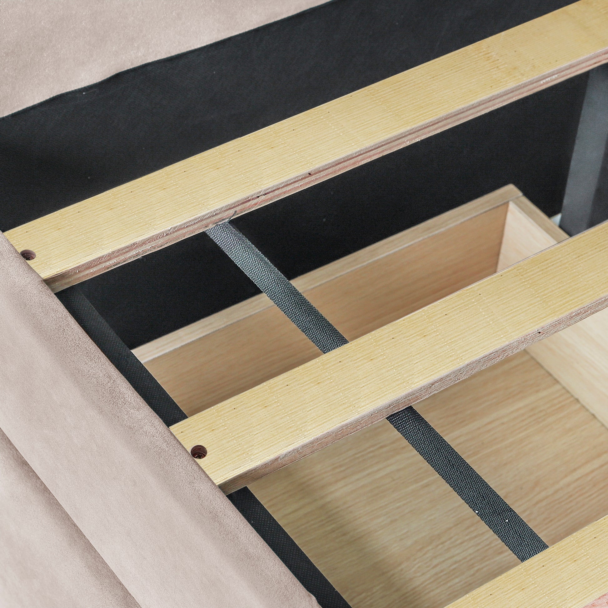 Beige upholstered bed frame with visible wooden slats and storage drawer
