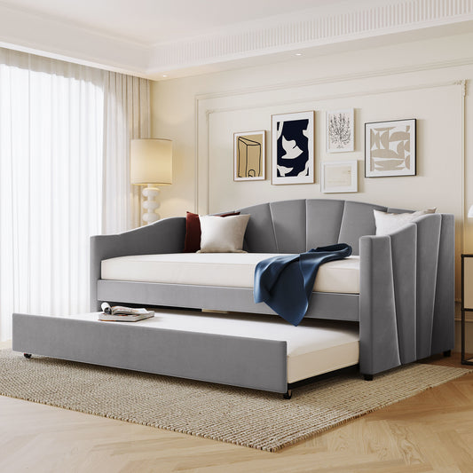 Modern grey upholstered daybed with a pullout trundle perfect for guest rooms