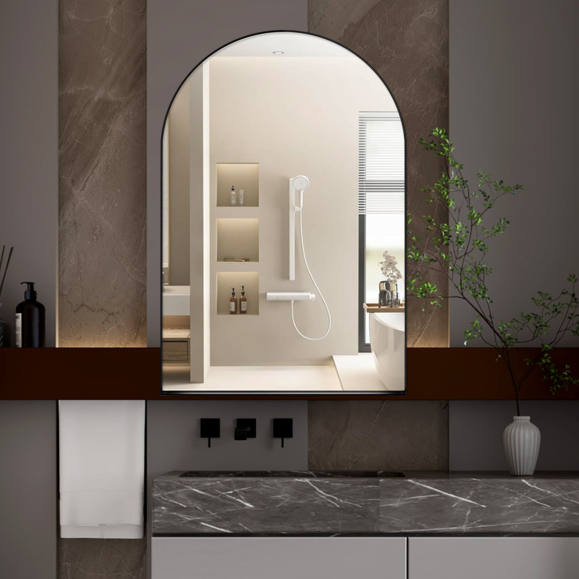 Black framed arched vanity mirror with a modern minimalist bathroom setting reflection