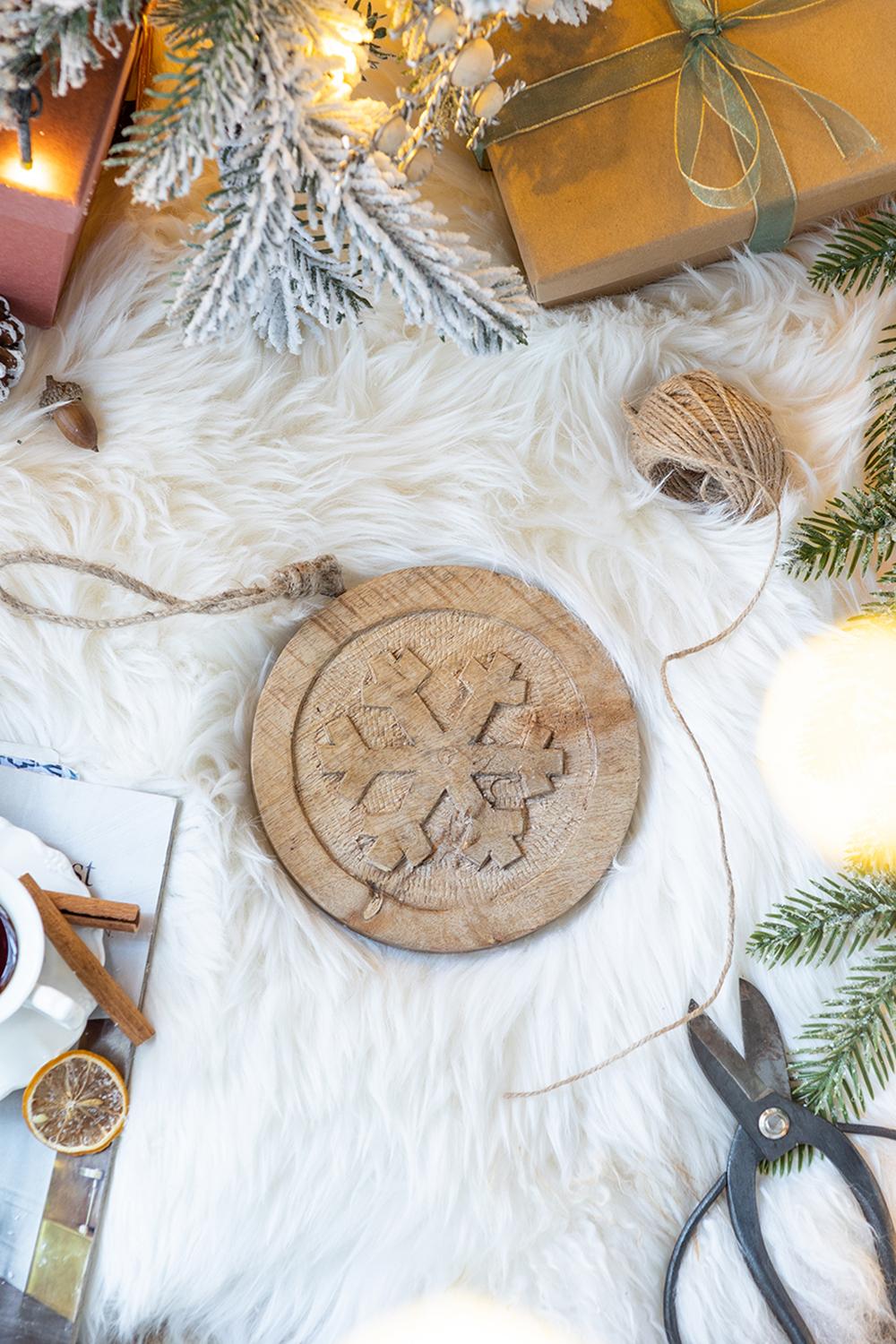 Rustic wooden snowflake ornament with carved detail ideal for holiday decor