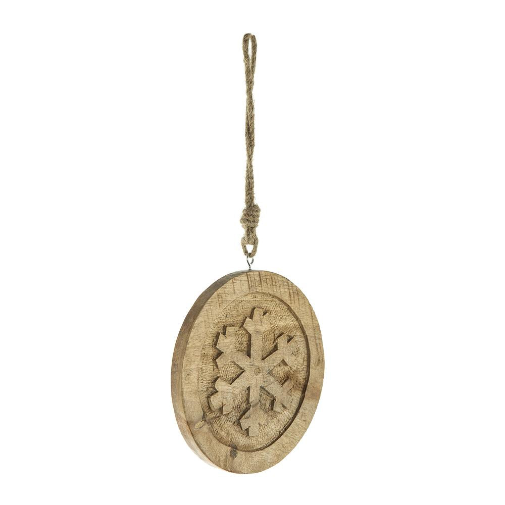 Rustic wooden round ornament with carved snowflake design suspended by jute twine
