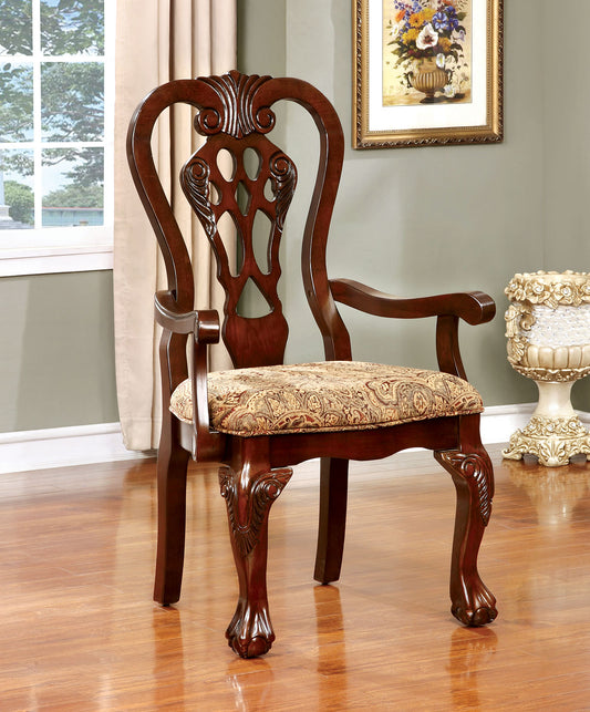 Ornate dark wood dining chair with upholstered patterned seat and scrolled arms