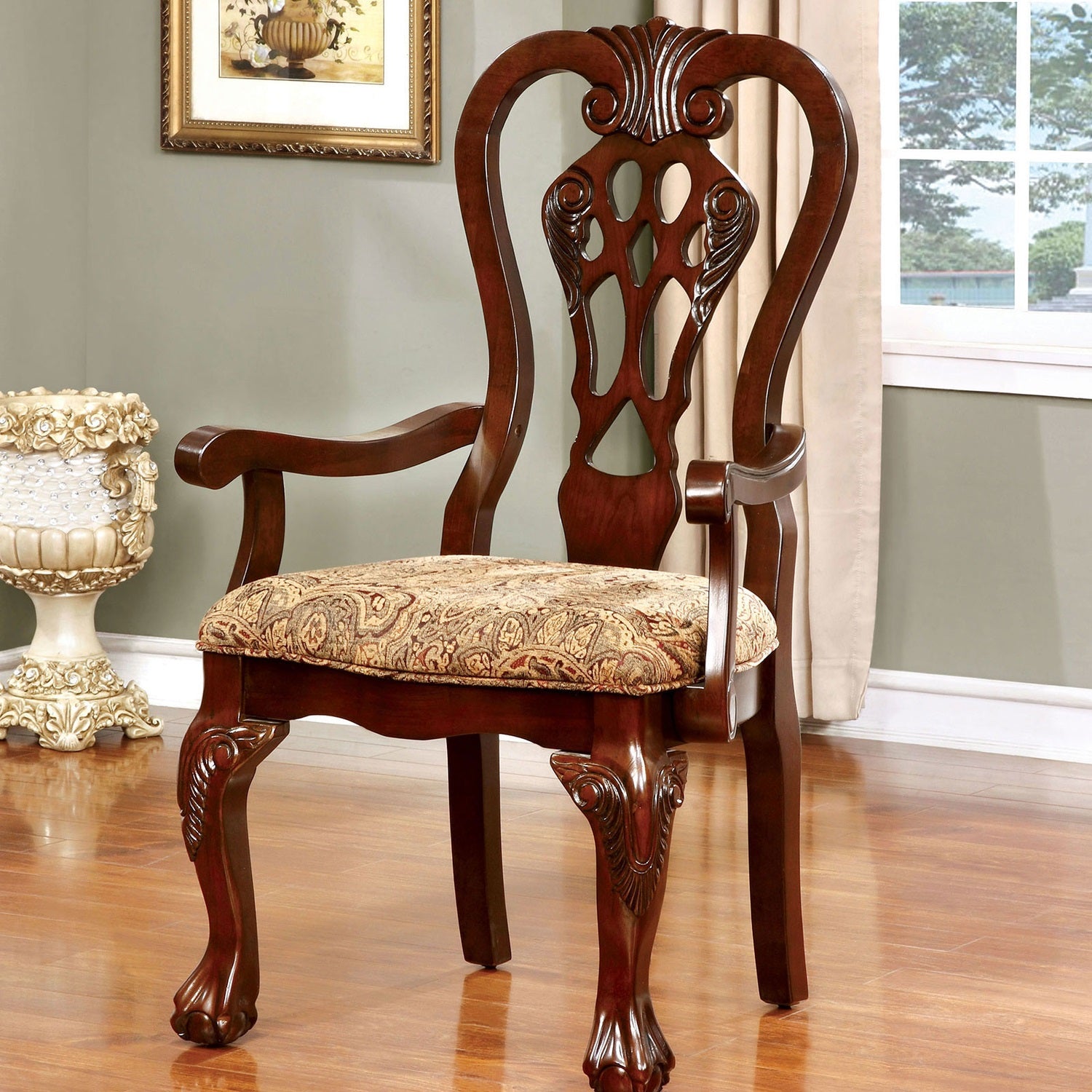 Ornate mahogany dining chair with upholstered floral seat and claw feet