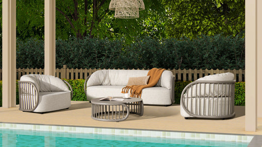Modern gray outdoor sofa with plush cushions and an orange throw blanket
