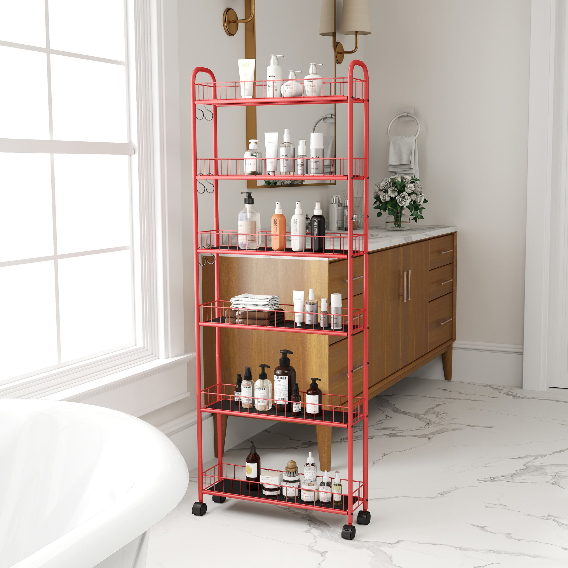 Red metal tier rolling cart filled with various skincare and haircare bottles and towels