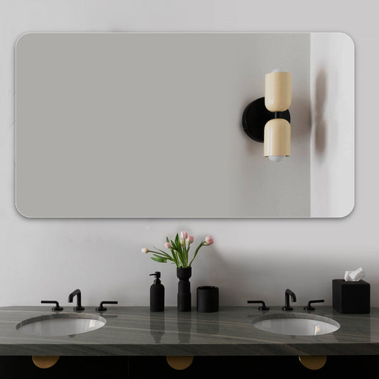Large frameless rectangular bathroom mirror with rounded corners above a double vanity