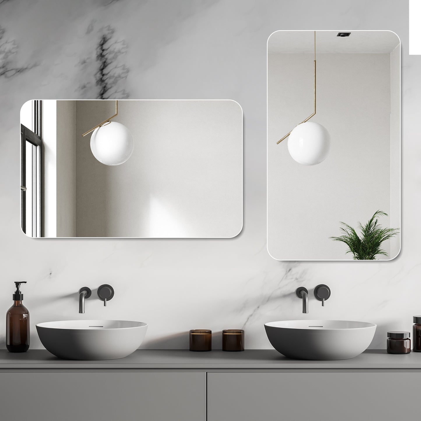 Rounded rectangular frameless bathroom mirror with brass accent and white orb pendant light above