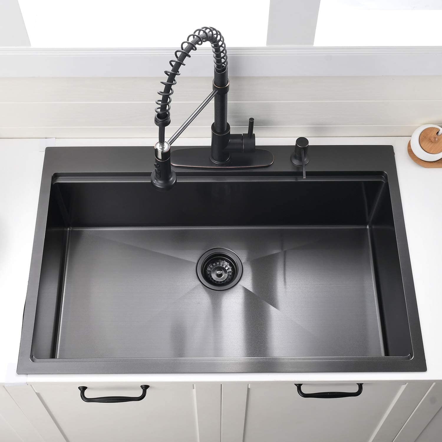 Black stainless steel kitchen sink with pulldown faucet and soap dispenser