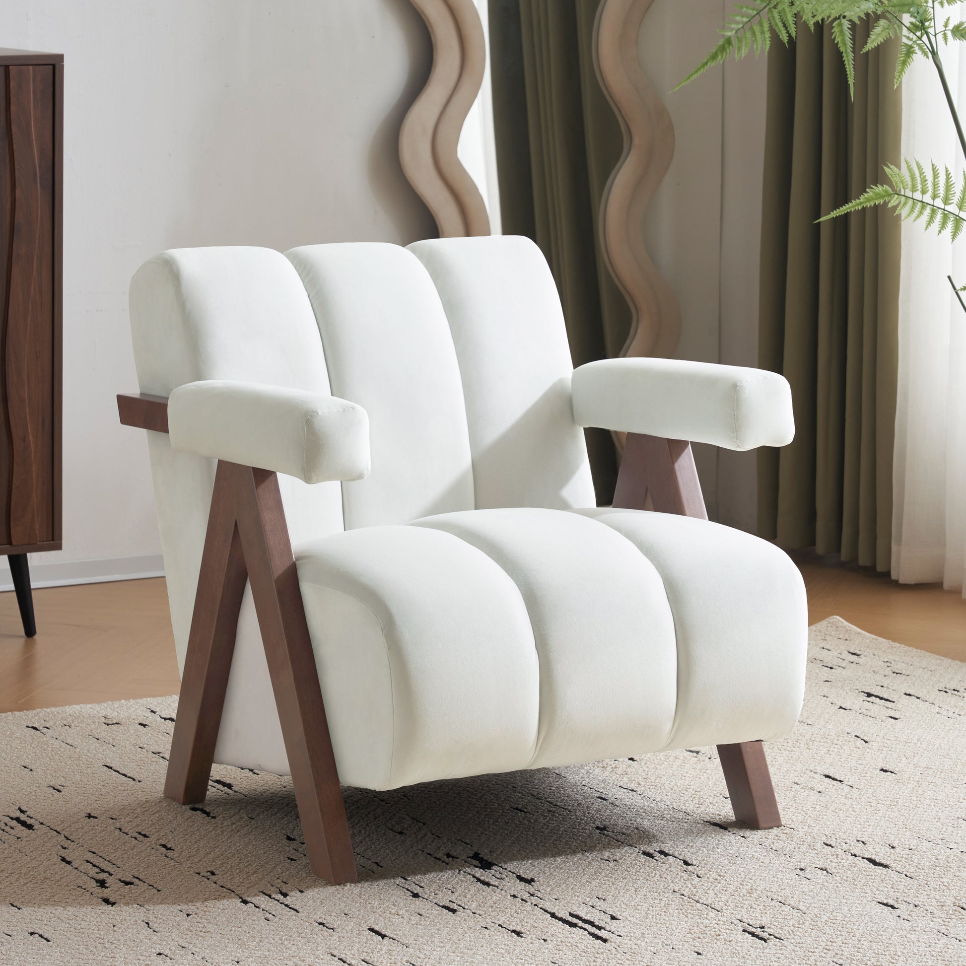 Plush white velvet armchair with channel tufting and angled wooden legs for a modern living room