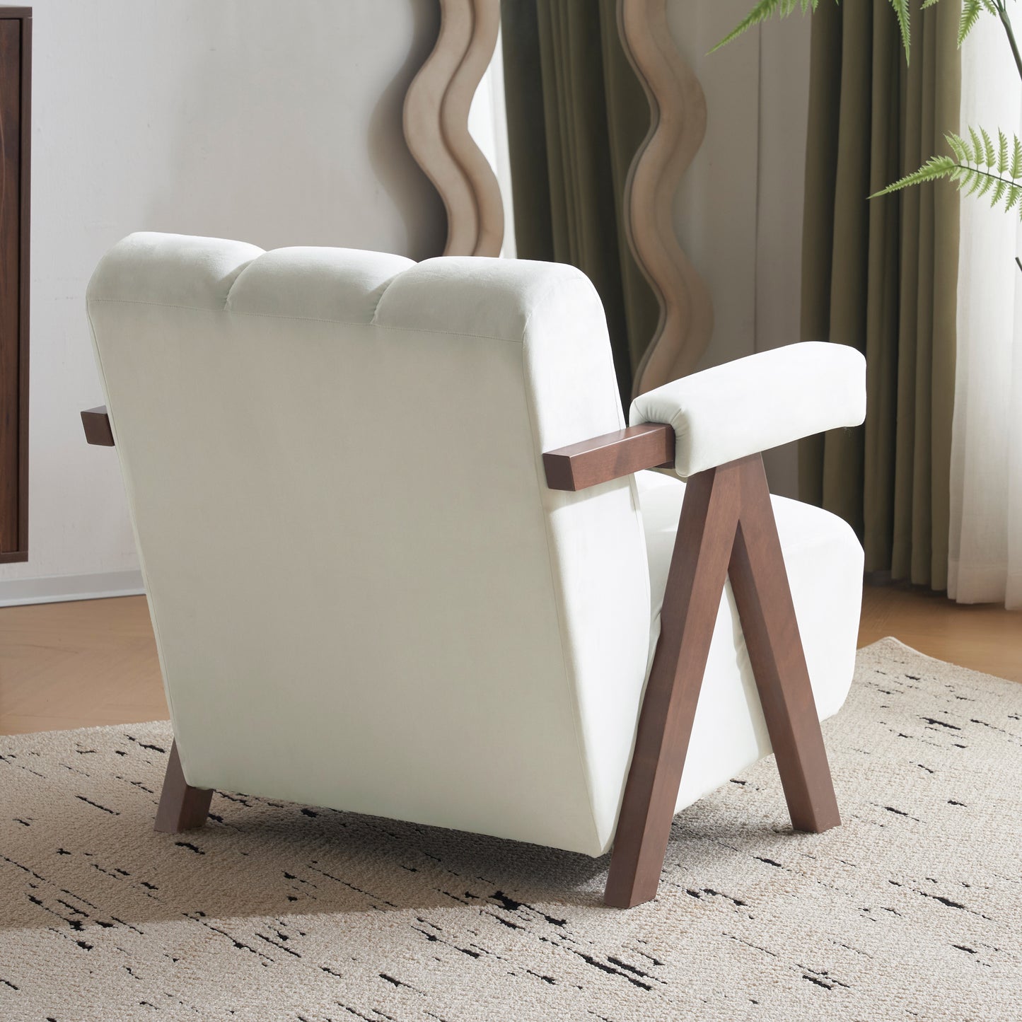 Modern cream velvet armchair with angled wooden legs