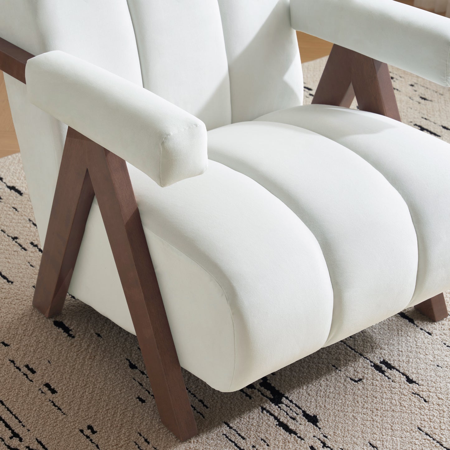Plush cream velvet armchair with dark wood geometric legs perfect for modern living rooms