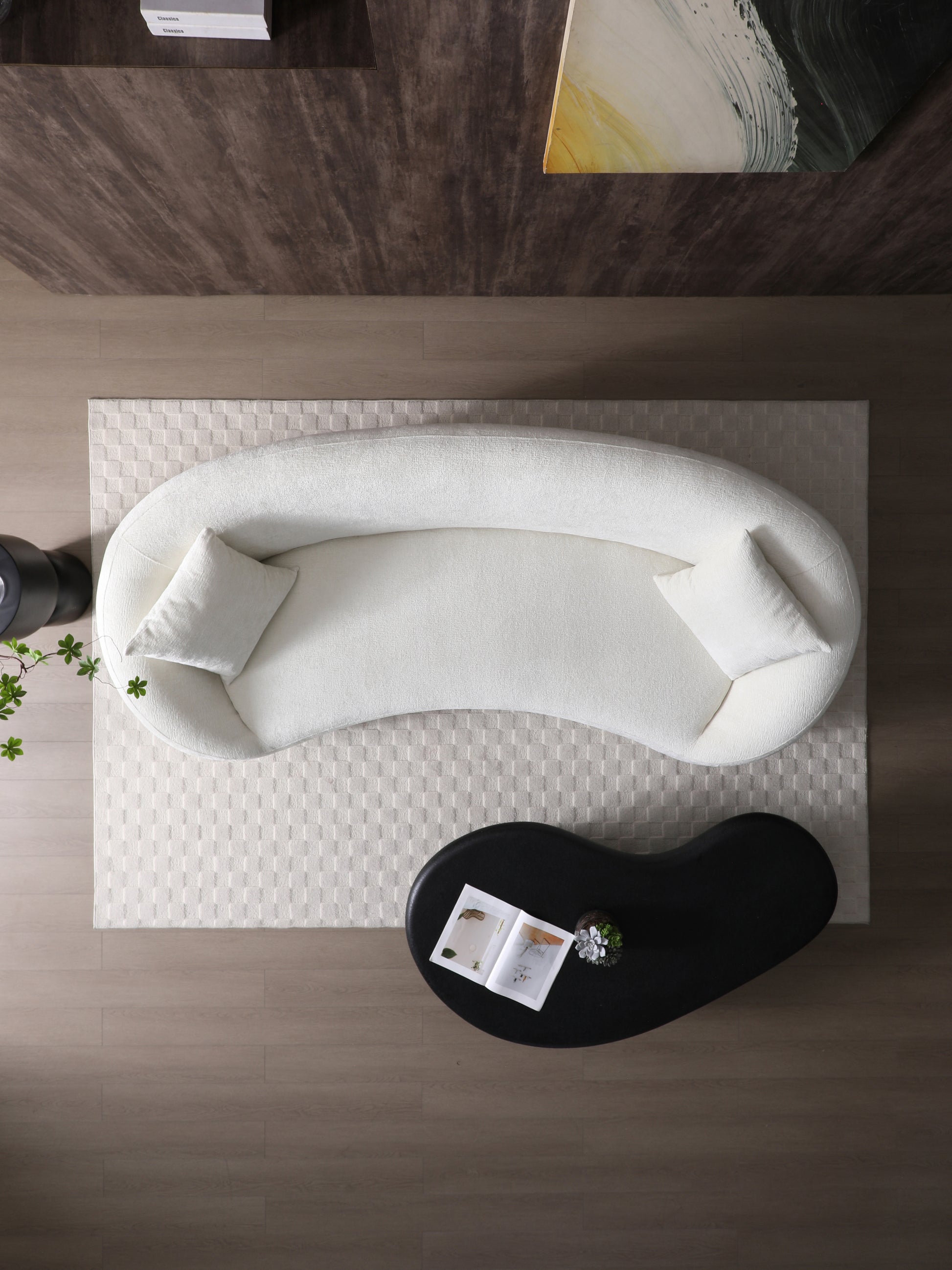 Plush white boucle sofa with curved silhouette and two throw pillows