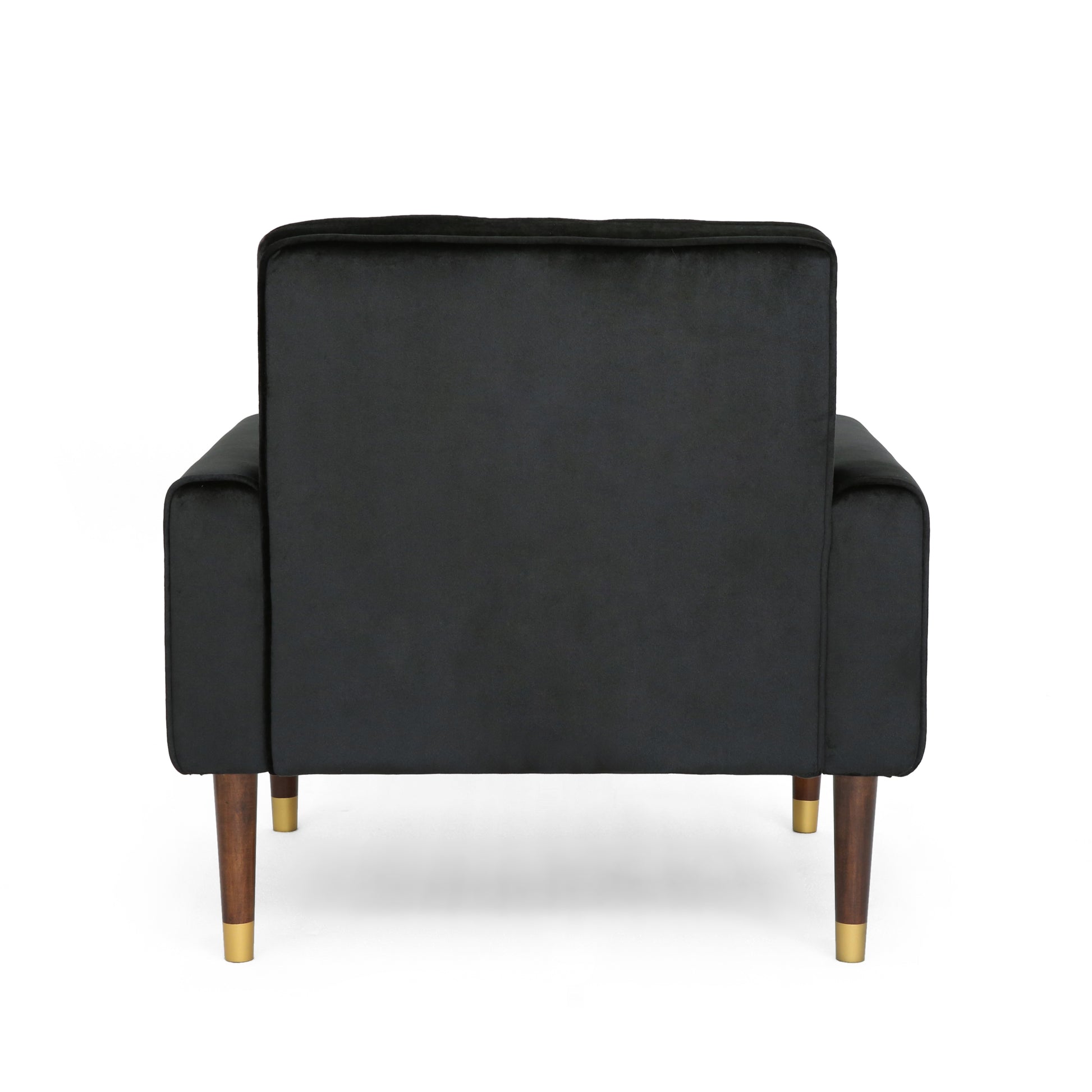Back view of a plush black velvet armchair with dark wood legs and brass accents